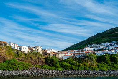 Town by buildings in city against sky