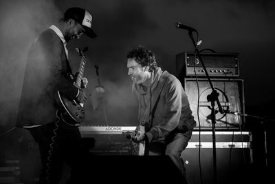 Man playing guitar at music concert