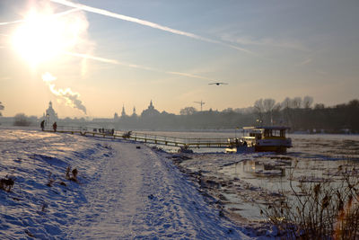 Panoramic view of frozen lake against sky during sunset