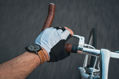 Cropped image of man riding bicycle on road