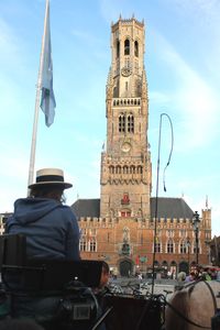 Rear view of man in building against sky