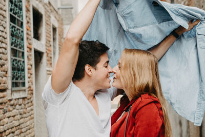 Rear view of couple kissing outdoors