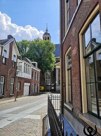 Street amidst buildings against sky