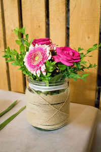 High angle view of pink flowers in vase on table