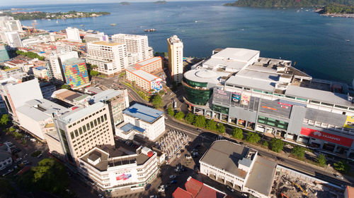 High angle view of buildings and sea in city