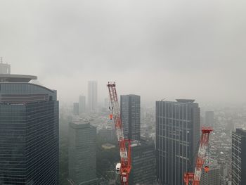 Modern buildings in city against sky