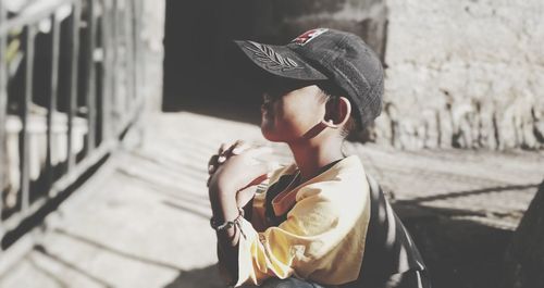 Rear view of boy looking at camera