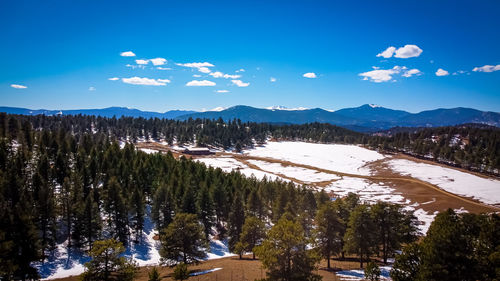 Scenic view of snowcapped mountains against blue sky