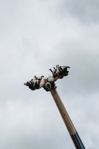 Low angle view of amusement park ride against sky