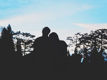 Low angle view of silhouette trees against sky