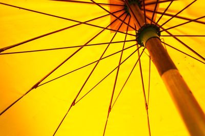 Low angle view of yellow umbrella against sky