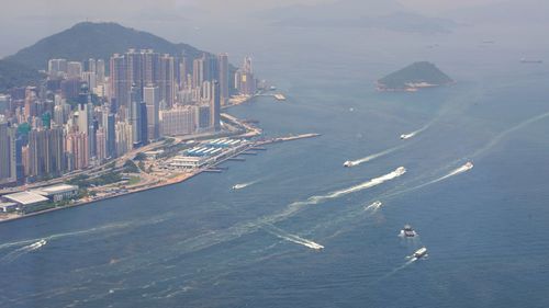 High angle view of sea and buildings in city