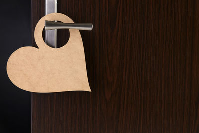 Close-up of paper hanging on wooden door