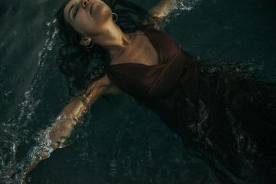 High angle view of woman lying in swimming pool