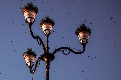 Low angle view of lamp hanging against clear sky