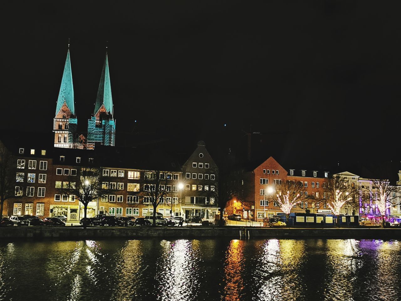 ILLUMINATED BUILDINGS AT WATERFRONT