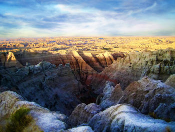 Scenic view of landscape against dramatic sky during sunset