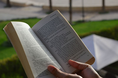 Cropped hands of person holding book