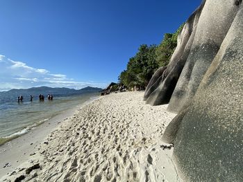 Scenic view of beach against blue sky