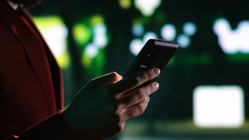 Midsection of woman using mobile phone