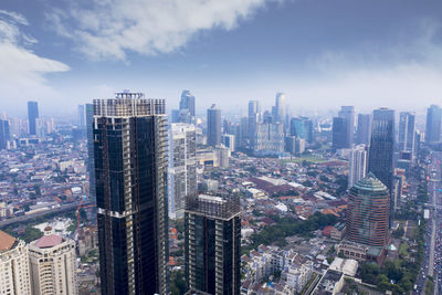 Aerial view of modern buildings in city against sky