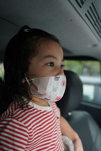 Portrait of cute girl in car