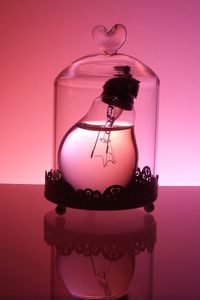 Light bulb in glass container on table