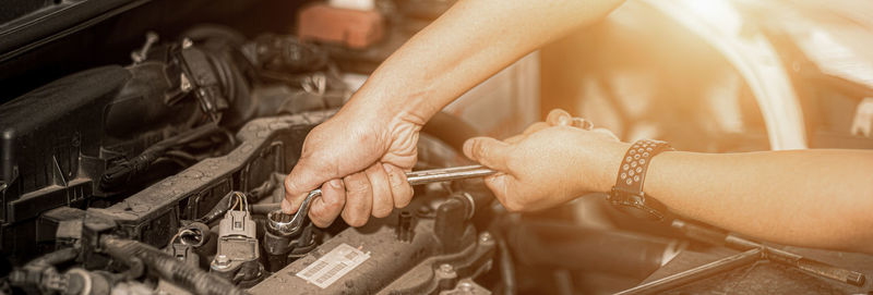 Midsection of man repairing car