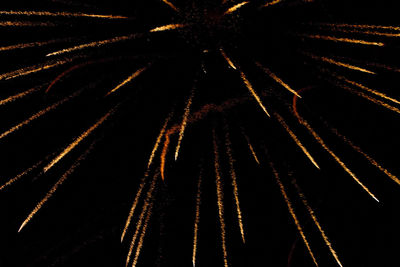 Low angle view of fireworks against sky at night