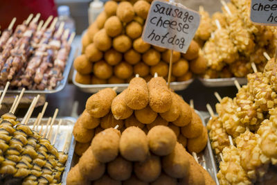 Street food stall in myeungdong packs food items selected by customers on in seoul, south korea.