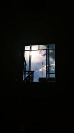 Low angle view of silhouette window in darkroom