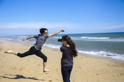 Full length of girl playing on beach