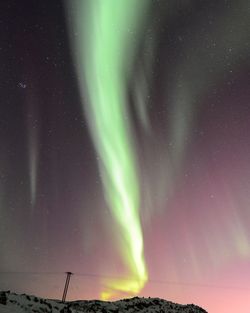 Low angle view of landscape against sky at night