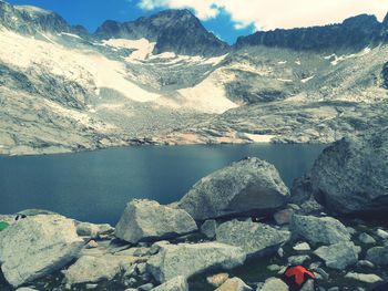 Scenic view of lake by mountains against sky