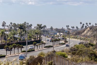 High angle view of cars on street against sky