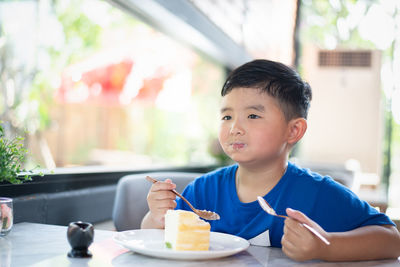 Portrait of boy eating food