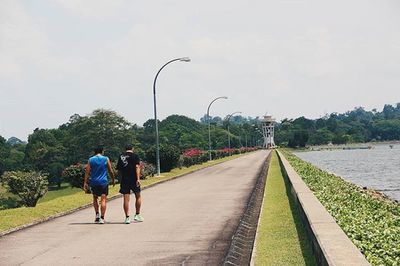 Full length of woman walking on footpath