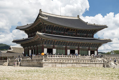 Low angle view of temple building against cloudy sky