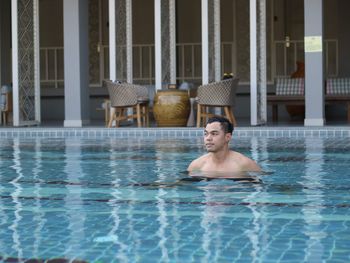 Shirtless young man in swiming pool