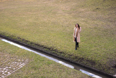 Full length of woman standing on field