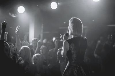 Rear view of man performing at music concert