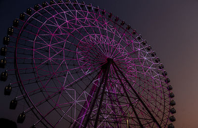 Ferris wheel changing colours at sunset