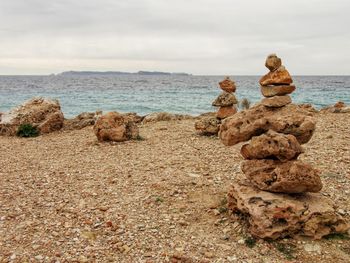 Rocks on beach against sky