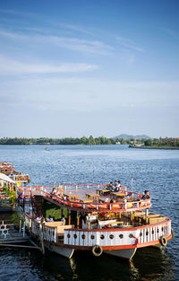 Boats moored in river against sky