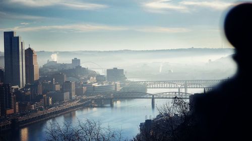 High angle view of river with buildings against the sky