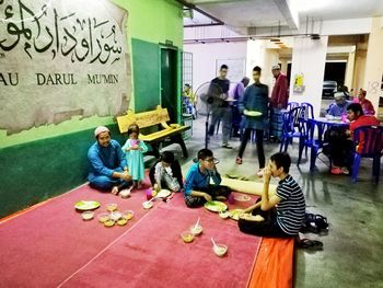 Group of people sitting in front of building