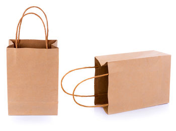 Close-up of brown shopping bags against white background