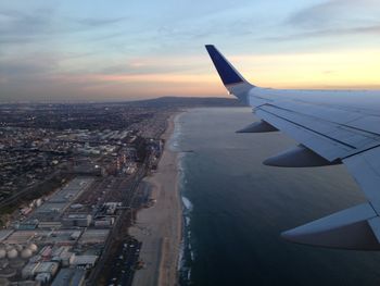 Aerial view of airplane wing against sky