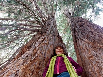 Laughing cute girl under a gigantic sequoia tree