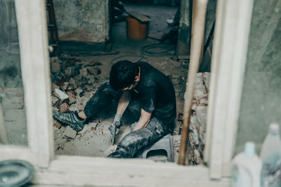 Rear view of man working at construction site
